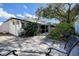Exterior view of backyard stone patio and well maintained landscaping at 2100 Mcmullen Rd, Largo, FL 33771
