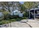 Backyard featuring concrete patio, lush green grass and landscaping near a white vinyl fence at 2100 Mcmullen Rd, Largo, FL 33771