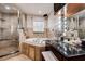 Well-appointed bathroom with a glass shower, soaking tub, and vanity area, providing a luxurious and functional space at 2100 Mcmullen Rd, Largo, FL 33771