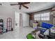 Bright bedroom with tile flooring, ceiling fan, closet, and view into the bathroom at 2100 Mcmullen Rd, Largo, FL 33771