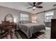 Cozy bedroom with wood floors, ceiling fan, desk and sliding door leading to modern ensuite bathroom at 2100 Mcmullen Rd, Largo, FL 33771