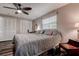 Comfortable bedroom featuring hardwood floors, a ceiling fan, and a vanity area, offering a relaxing retreat at 2100 Mcmullen Rd, Largo, FL 33771