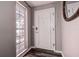 Bright entryway featuring decorative glass window and white front door leading into the home at 2100 Mcmullen Rd, Largo, FL 33771