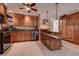 Spacious kitchen featuring tile floors, wood cabinets, and stainless steel appliances at 2100 Mcmullen Rd, Largo, FL 33771