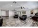 Spacious living room featuring luxury vinyl plank flooring, ceiling fans, and neutral decor at 2100 Mcmullen Rd, Largo, FL 33771