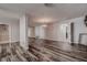 Open-concept living space with luxury vinyl plank floors and a decorative chandelier at 2100 Mcmullen Rd, Largo, FL 33771