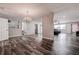 Open living area with luxury vinyl plank floors, chandelier, and view into the adjacent seating area at 2100 Mcmullen Rd, Largo, FL 33771