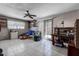 Large living room with tile floors, a ceiling fan, and sliding glass doors to the outside at 2100 Mcmullen Rd, Largo, FL 33771