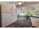 Outdoor porch with ceiling fans, brick floors and a table with chairs at 2100 Mcmullen Rd, Largo, FL 33771