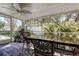 Screened porch with ceiling fan and outdoor dining set at 2100 Mcmullen Rd, Largo, FL 33771