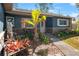 Inviting front porch with stone accents, a small table and chairs, and colorful landscaping at 22700 Southshore Dr, Land O Lakes, FL 34639