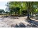 Community playground under mature trees with play equipment and picnic area at 22700 Southshore Dr, Land O Lakes, FL 34639