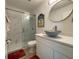 Modern bathroom featuring a stylish vanity, unique sink, and glass-enclosed shower at 250 Rosery Nw Rd # 329, Largo, FL 33770