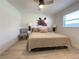 Comfortable bedroom with a ceiling fan, stylish decor, and natural light from the window at 250 Rosery Nw Rd # 329, Largo, FL 33770