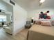 Bright bedroom with a connecting living room, a comfortable bed, and a ceiling fan at 250 Rosery Nw Rd # 329, Largo, FL 33770