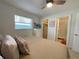 Light bedroom with a closet, ensuite bathroom and window at 250 Rosery Nw Rd # 329, Largo, FL 33770