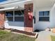 Charming brick exterior detail with awning-covered windows and a well-maintained front garden at 250 Rosery Nw Rd # 329, Largo, FL 33770