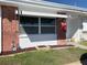 Charming brick exterior detail with awning-covered windows and a well-maintained front garden at 250 Rosery Nw Rd # 329, Largo, FL 33770
