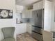 Charming kitchen with white cabinets, stainless steel refrigerator, and breakfast table nearby at 250 Rosery Nw Rd # 329, Largo, FL 33770