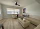 Well-lit living area with comfortable seating, ceiling fan, and modern artistic touches at 250 Rosery Nw Rd # 329, Largo, FL 33770