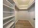 Large walk-in closet with built-in shelving at 250 Rosery Nw Rd # 329, Largo, FL 33770