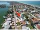 A residential neighborhood with waterfront access featuring a home with a private pool and solar panels on the roof at 2504 Bayshore Dr, Belleair Beach, FL 33786