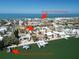 Aerial view of residential neighborhood with water access, a local fishing dock, and a direct path to Morgan Beach at 2504 Bayshore Dr, Belleair Beach, FL 33786