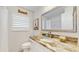 Bathroom featuring a granite countertop, stylish decor, and tiled shower at 2504 Bayshore Dr, Belleair Beach, FL 33786
