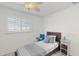 Cozy bedroom featuring a twin bed, side table and bright natural light at 2504 Bayshore Dr, Belleair Beach, FL 33786