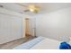 Bright bedroom with wood-look flooring, ceiling fan, and closet storage at 2504 Bayshore Dr, Belleair Beach, FL 33786