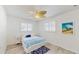 Cozy bedroom with bright white walls, wood-look flooring and coastal decor at 2504 Bayshore Dr, Belleair Beach, FL 33786