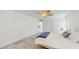 Bright bedroom with wood-look flooring, ceiling fan and ample closet space at 2504 Bayshore Dr, Belleair Beach, FL 33786