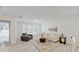 Bright living room with neutral decor, plantation shutters, stylish furniture, and tile flooring at 2504 Bayshore Dr, Belleair Beach, FL 33786