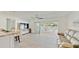 Open living area with modern flooring and access to the outdoor pool and patio at 2504 Bayshore Dr, Belleair Beach, FL 33786