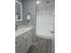 Modern bathroom with a white vanity, new floors, and updated shower at 2630 Pearce Dr # 103, Clearwater, FL 33764