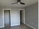 Clean bedroom with ceiling fan, closet, plank flooring and doorway to bathroom at 2630 Pearce Dr # 103, Clearwater, FL 33764
