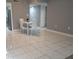 Open-concept dining area with tile floors, view into kitchen and doorway to another room at 2630 Pearce Dr # 103, Clearwater, FL 33764