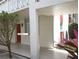 The walkway and entrance of Condo #103 surrounded by flowers at 2630 Pearce Dr # 103, Clearwater, FL 33764