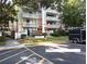 Exterior facade of Condo #103 with guest parking and mature tree in view at 2630 Pearce Dr # 103, Clearwater, FL 33764