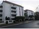 Exterior view of the building featuring multiple balconies and mature landscaping at 2630 Pearce Dr # 103, Clearwater, FL 33764