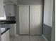 Kitchen area featuring white cabinets, granite counters, and closet at 2630 Pearce Dr # 103, Clearwater, FL 33764