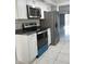 Well-lit kitchen with stainless steel appliances and white cabinets, providing a clean and functional space at 2630 Pearce Dr # 103, Clearwater, FL 33764