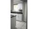 Bright kitchen with modern appliances, granite countertops, and white cabinetry at 2630 Pearce Dr # 103, Clearwater, FL 33764
