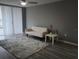 Cozy living room with neutral sofa, textured rug, and sliding glass doors with vertical blinds at 2630 Pearce Dr # 103, Clearwater, FL 33764