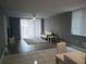 Bright living room features sliding glass doors, a comfortable sofa and stylish decor at 2630 Pearce Dr # 103, Clearwater, FL 33764