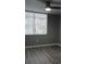 Bright living room with wood-look flooring and a window with vertical blinds, creating a comfortable living space at 2630 Pearce Dr # 103, Clearwater, FL 33764