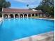 Large outdoor pool with lounge seating and shade at 2630 Pearce Dr # 103, Clearwater, FL 33764