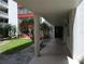 A shaded walkway provides access to units surrounded by tropical landscaping at 2630 Pearce Dr # 103, Clearwater, FL 33764