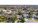 Residential aerial view showing many houses with pools in a lush neighborhood at 2725 Onizuka Ct, Palm Harbor, FL 34683