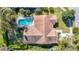 Aerial view of home featuring a large roof, pool, and green lawn at 2725 Onizuka Ct, Palm Harbor, FL 34683